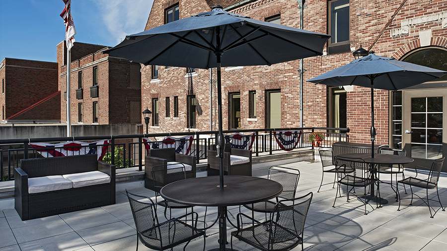 Patio tables and seating at American House Grosse Pointe Cottage Senior Living Facility