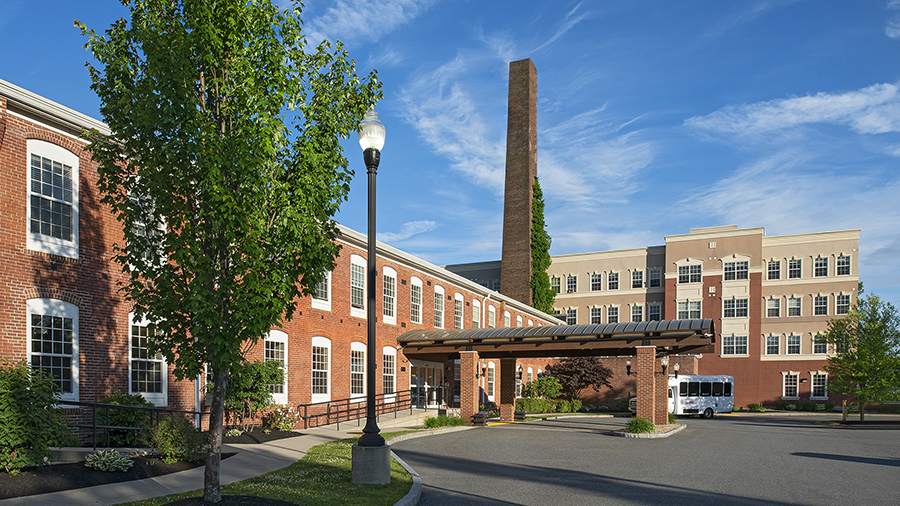Front entrance and driveway at American House Keene senior living community in Keene, NH