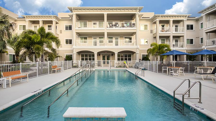 Accessible heated outdoor pool at American House St. Petersburg Independent Living, Assisted Living, and Memory Care senior living facility in St. Petersburg, FL