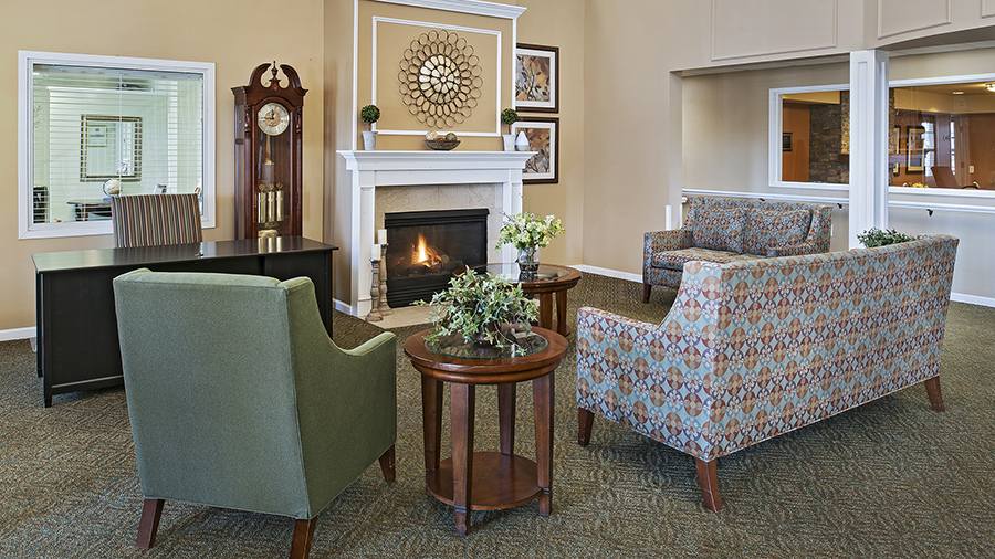Cozy fireplace and lobby at American House Troy, a Senior Living Community in Troy, MI